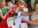Yvonne shared the table and explained how she sews greetings cards .